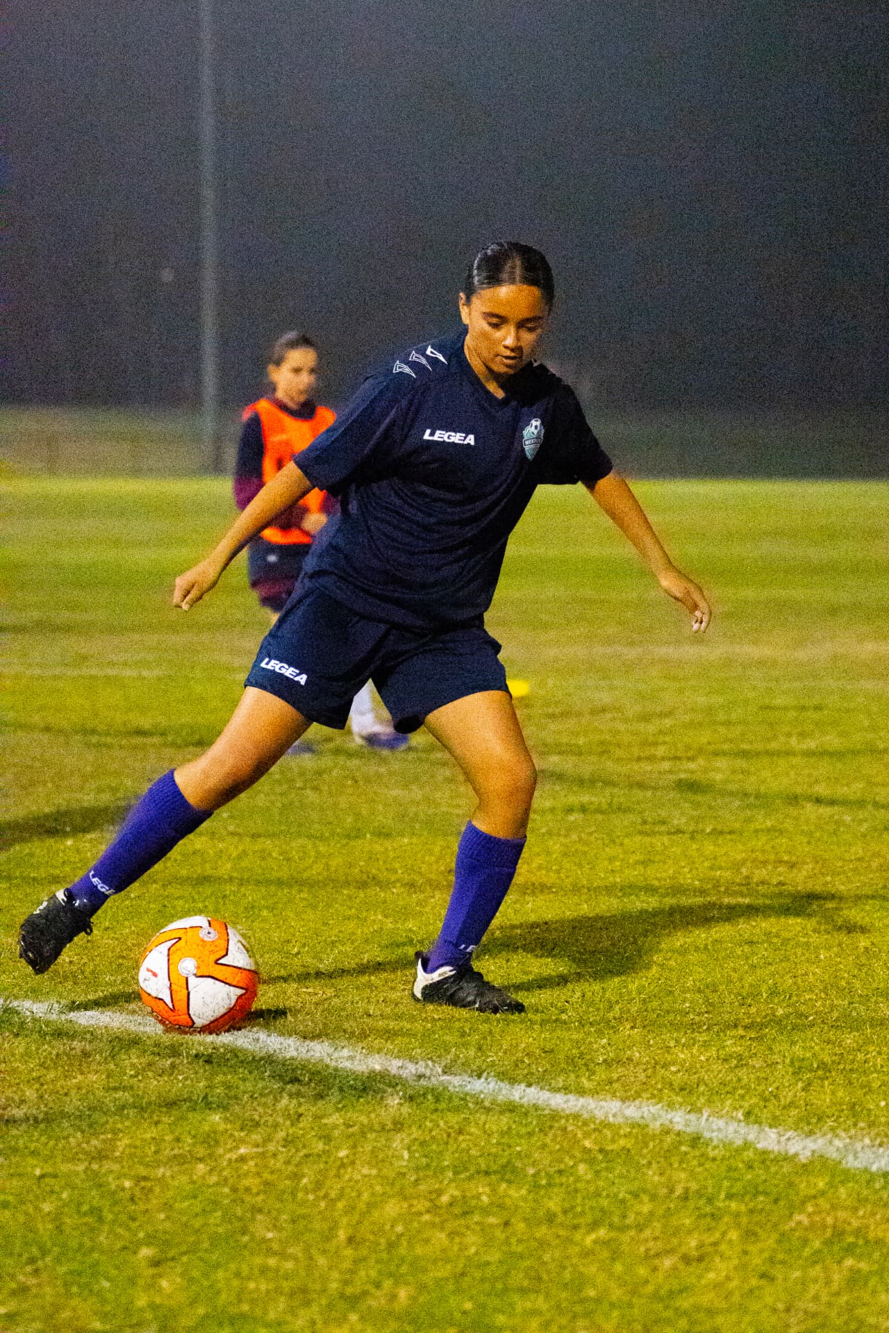 NextGen player practising a pass during an evening session